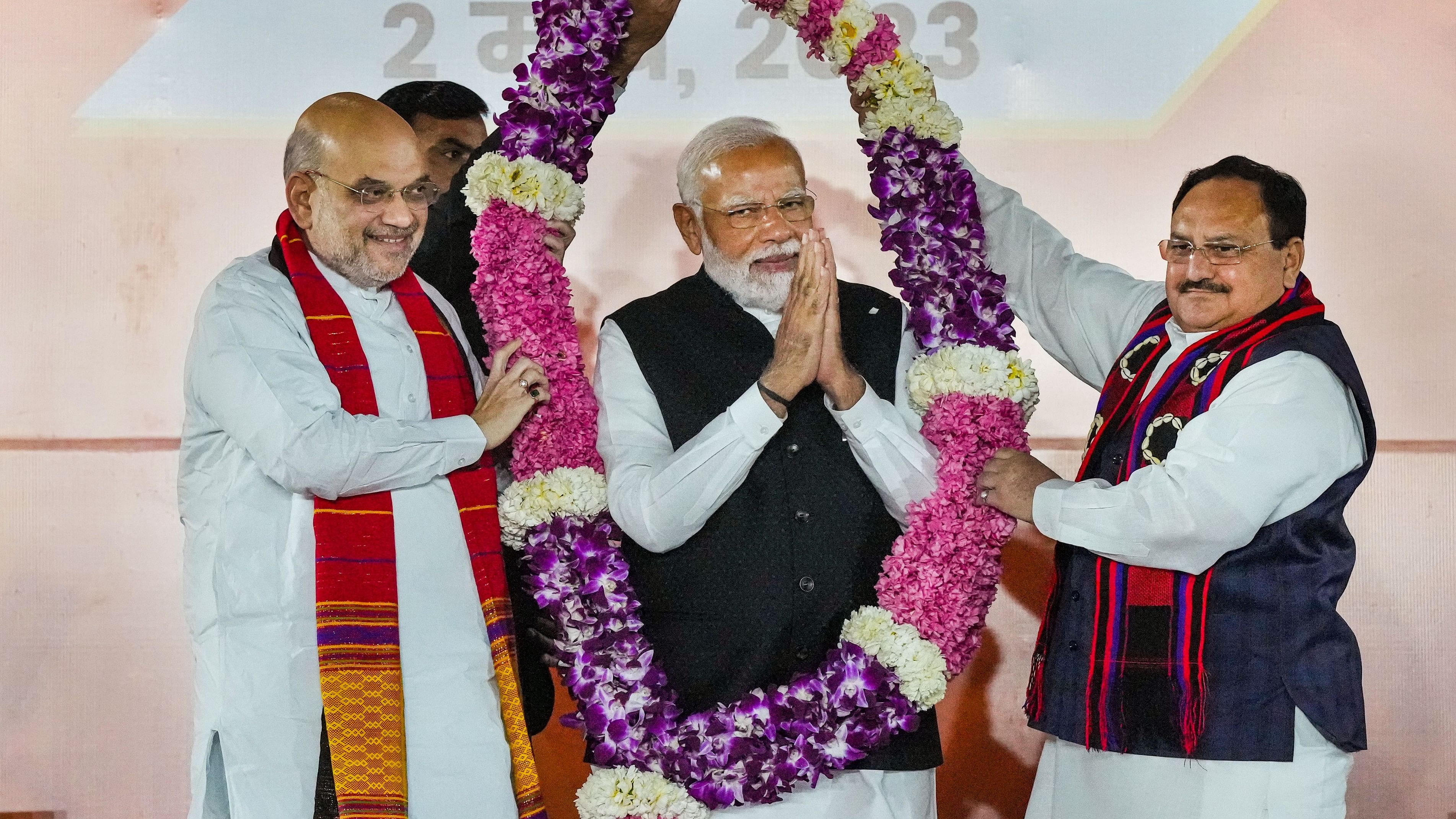 <div class="paragraphs"><p>File photo of Prime Minister Narendra Modi being garlanded by BJP President J P Nadda and Union Minister Amit Shah</p></div>